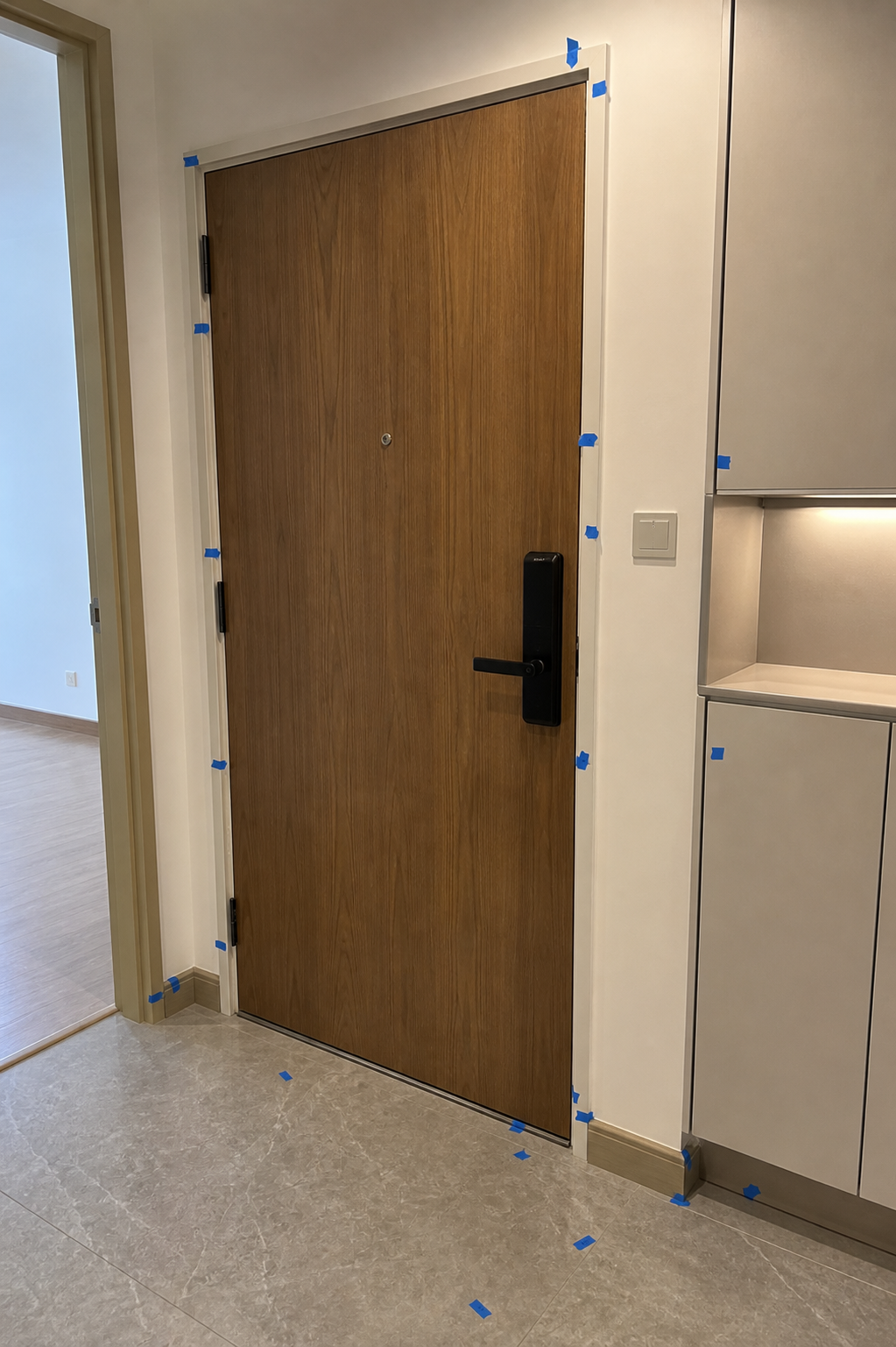Front door inspection — defects marked with blue tape